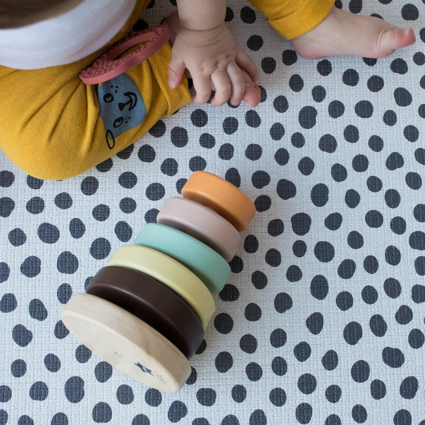 baby plays on soft spotty foam mat