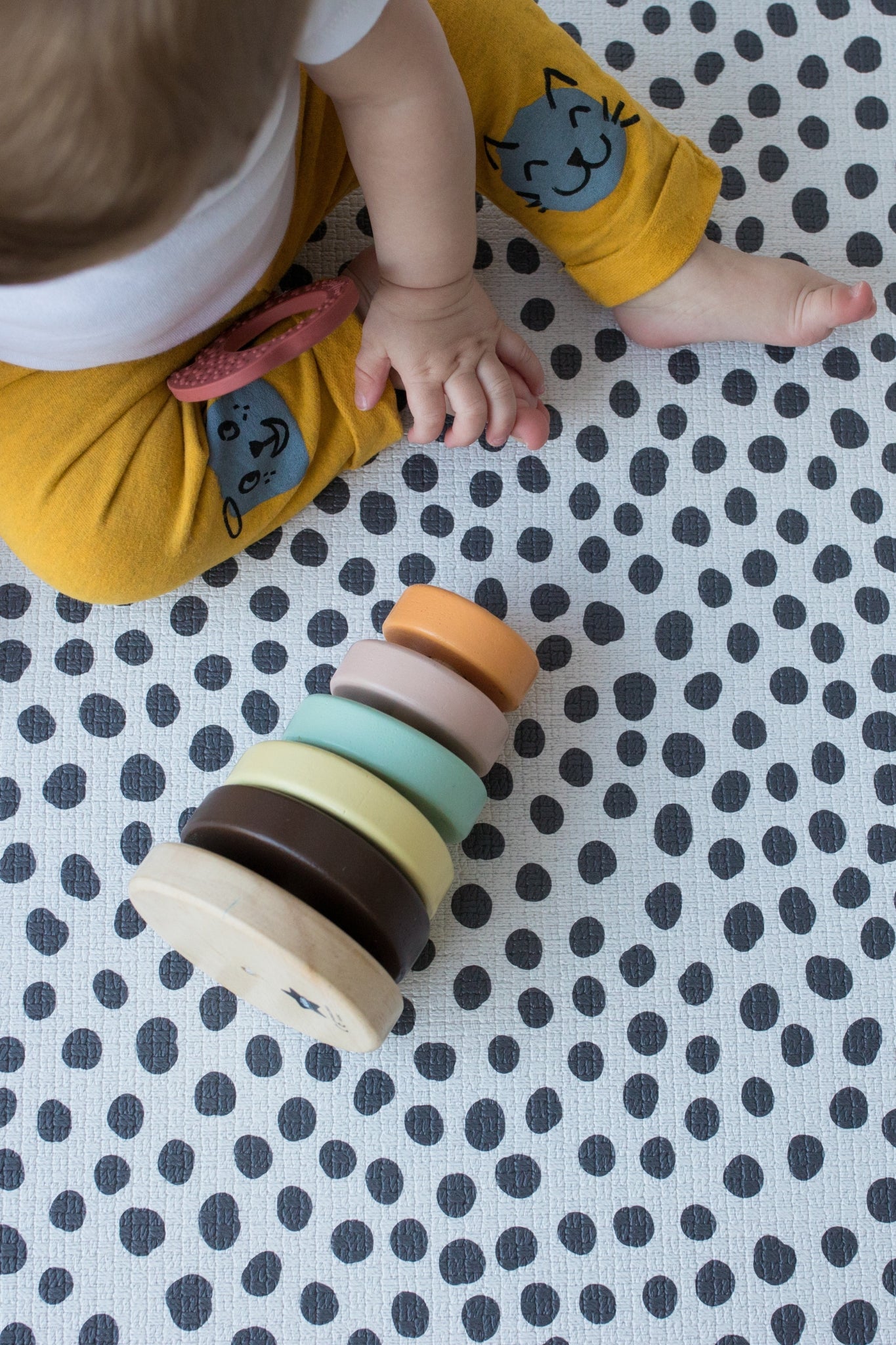 baby plays on soft spotty foam mat