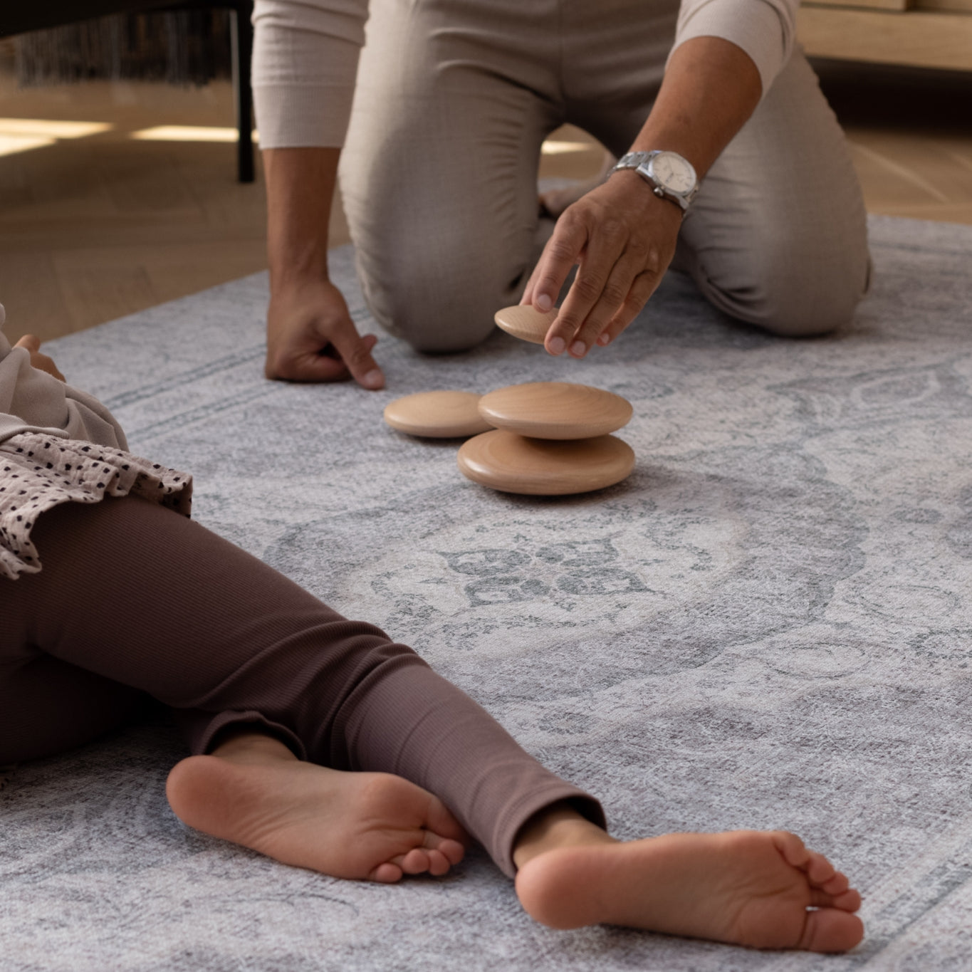 dad and child play on an elegant playmat rug