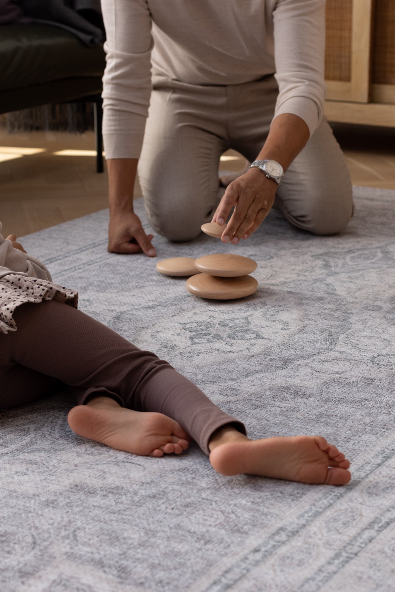 dad and child play on an elegant playmat rug