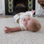 totter and tumble round Spielmatte in morris & co grey acorn print with baby rolling perfect safe and supportive play foam mats