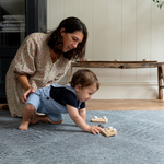 Mother and son enjoy play time on the memory foam spielmatte providing support during baby play time 