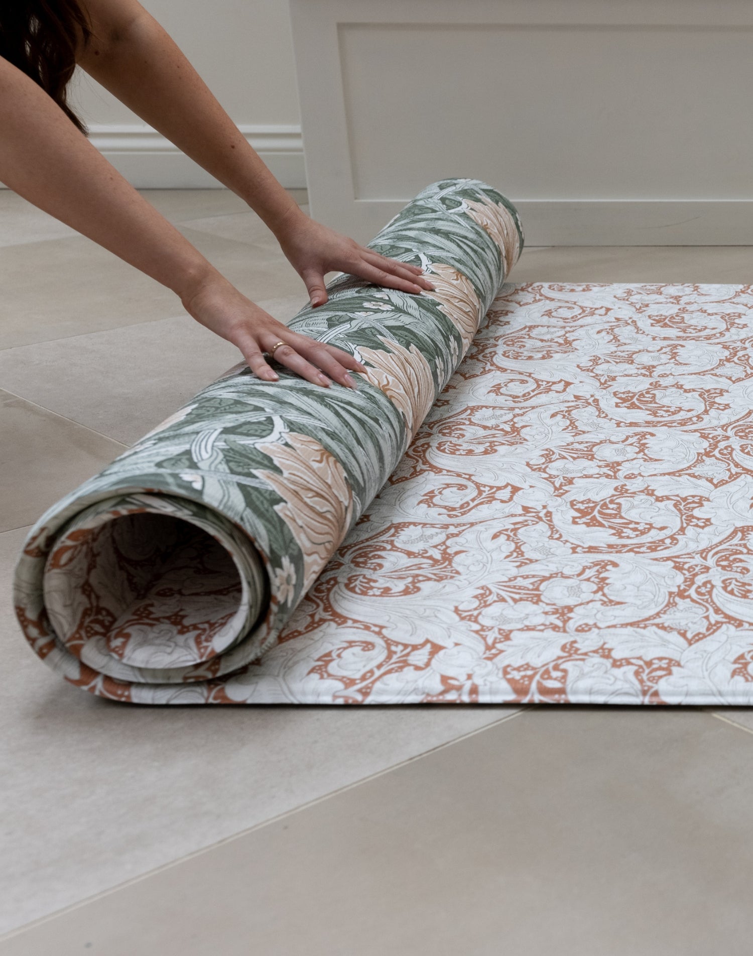 elegant totter and tumble playmat being rolled out on floor