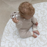 baby sitting on Totter and Tumble round neutral playmat