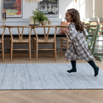 Child happily runs across a large memory foam rug for the living room