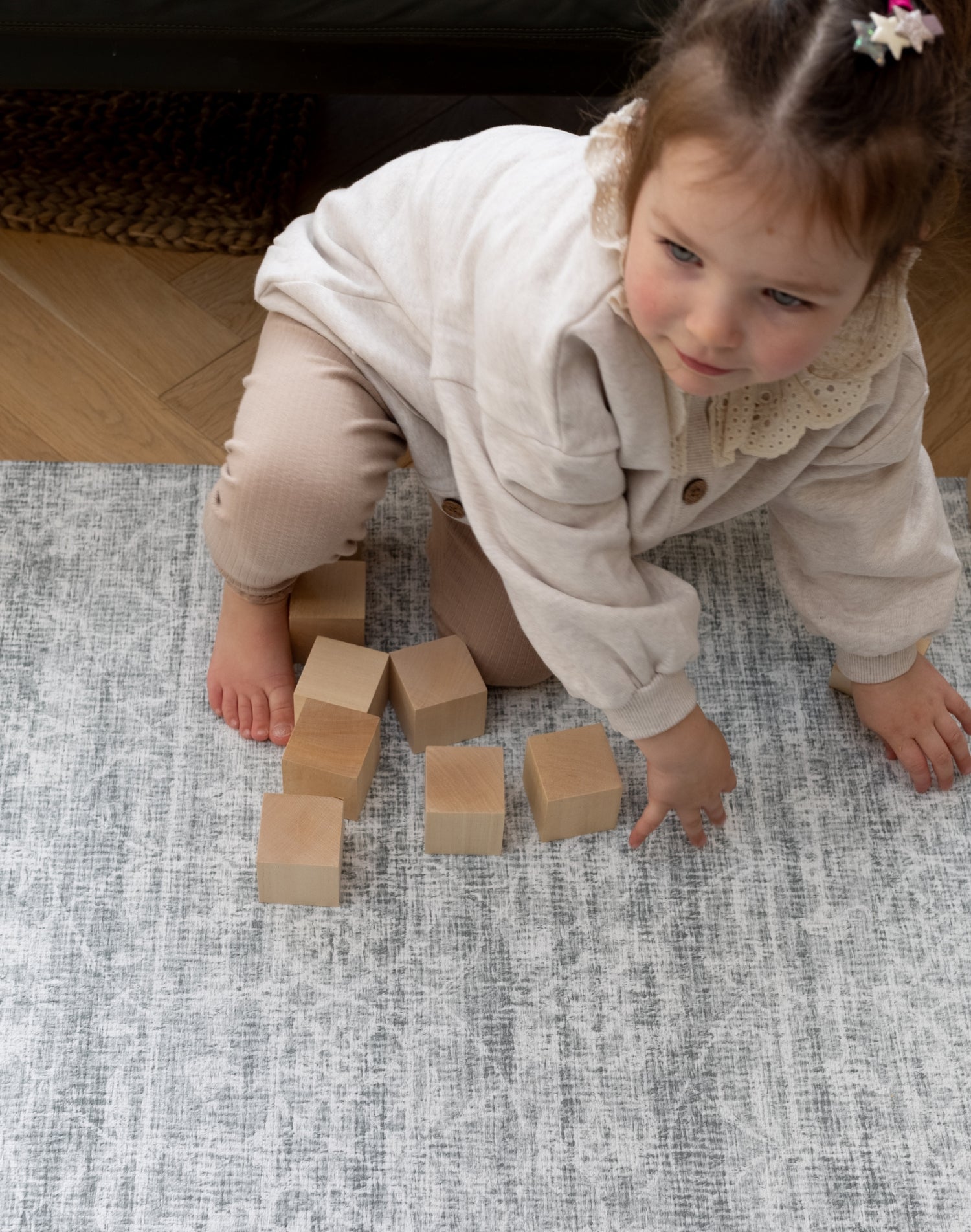 toddler plays on large padded playmat