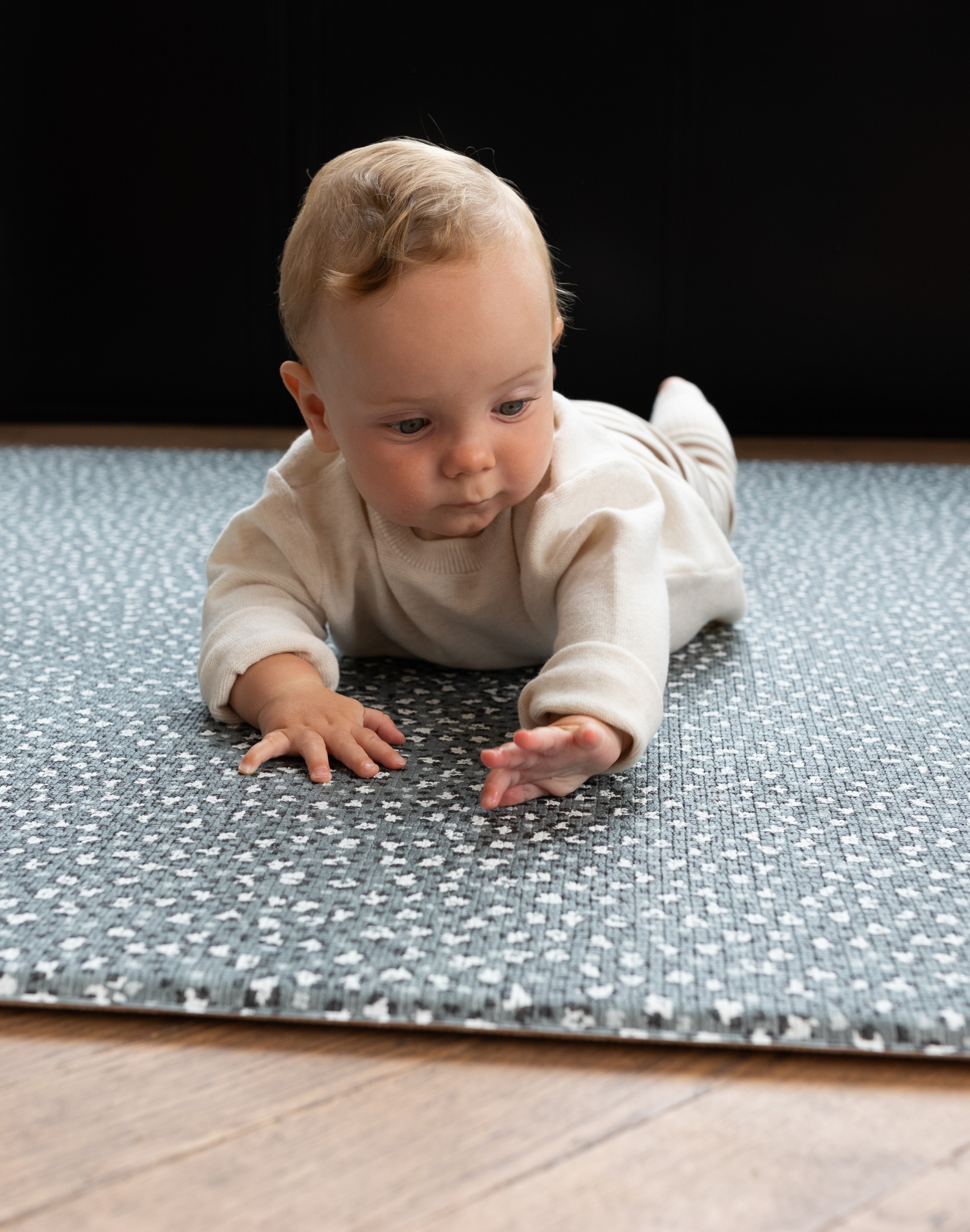 Baby enjoys tummy time on leopard print foam floor mat 