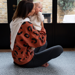 Lady and baby are protected on the thick padded floor mat by totter and tumble with a modern green design 