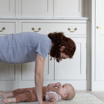 totter and tumble playmats are mutlfunctional play mats that can be used by mom and baby. Mother exercising with baby yoya playing together, foam play mat provides support and safe place for your baby on the floor