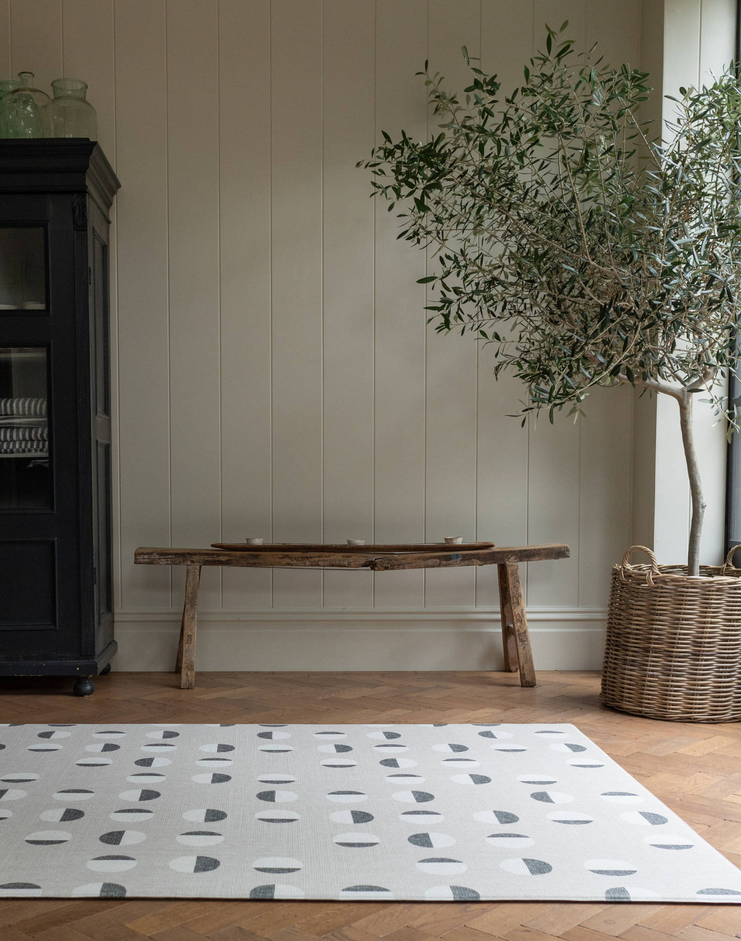 Organic polka dot baby play mat in neutral tones for a modern effect unrolled in a living space for safe playtime