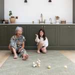 Lady and child enjoy play time together on the keuken mat in green tones to complement the kitchen 