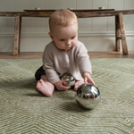 Cute baby enjoying sensory play on thick floor mat ideal for play time 