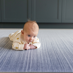 Baby enjoying tummy time on Baby play mats by Totter and Tumble are safe from birth and perfect for tummy time with mouldable memory foam to support little ones building strength 