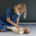 Mother and baby together on Baby play mats by Totter and Tumble are safe from birth and perfect for tummy time with mouldable memory foam to support little ones building strength 