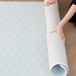 Placing the one piece play mat in place with a reversible design to complement modern interiors 