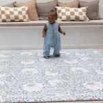 Baby standing on padded totter and tumble playmat from Morris and Co Collaboration