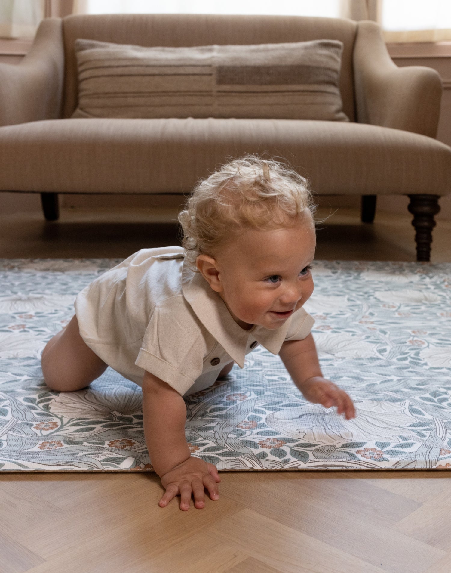 crawling baby on stylish William Morris playmat