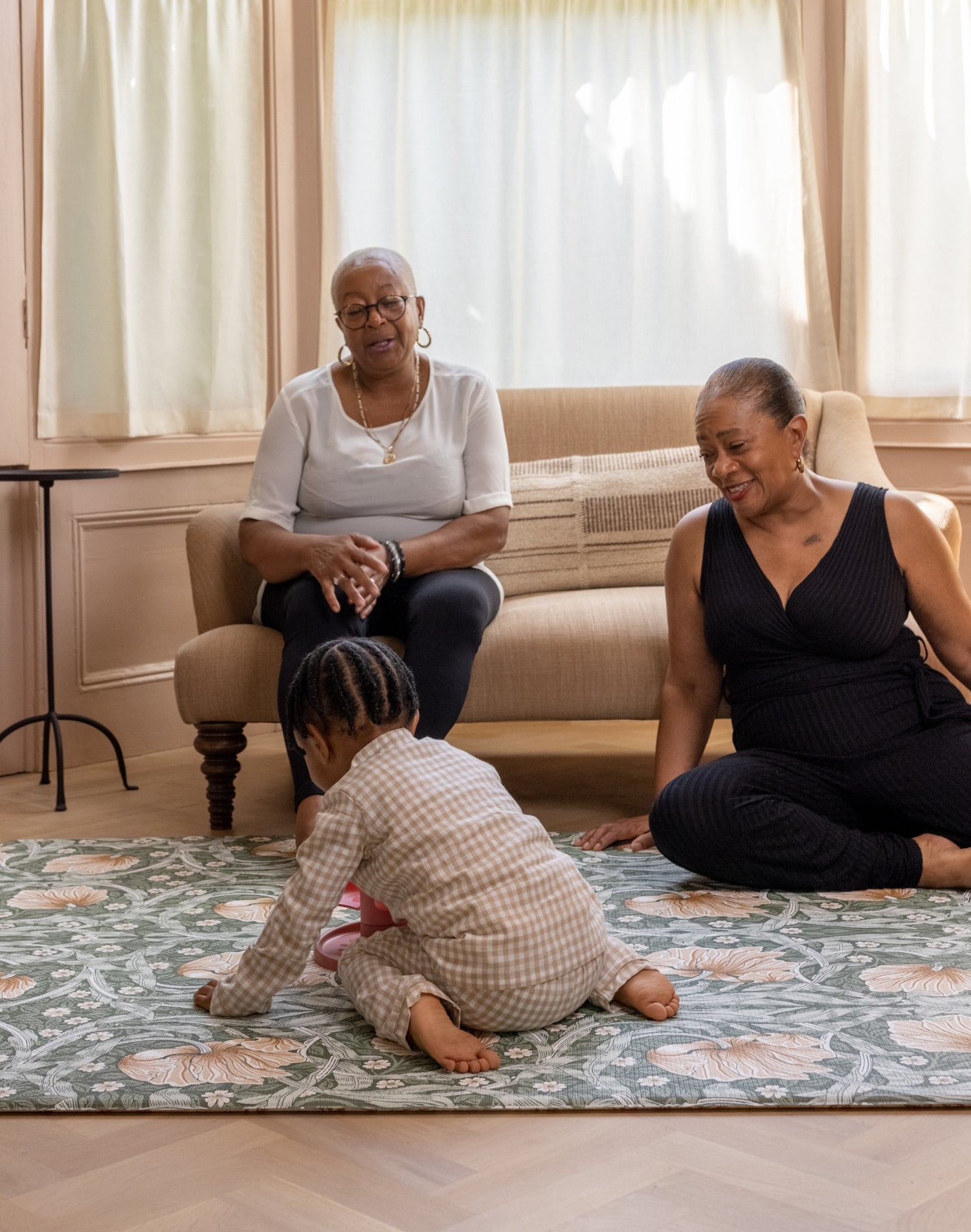 grandparents playing with toddler on comfy and stylish playmat