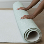 Unrolling the memory foam speelmat by Totter and Tumble with the subtle Rambler and Globe Trotter designs