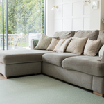 A living room looks modern with a green play mat that brings nature into the home 