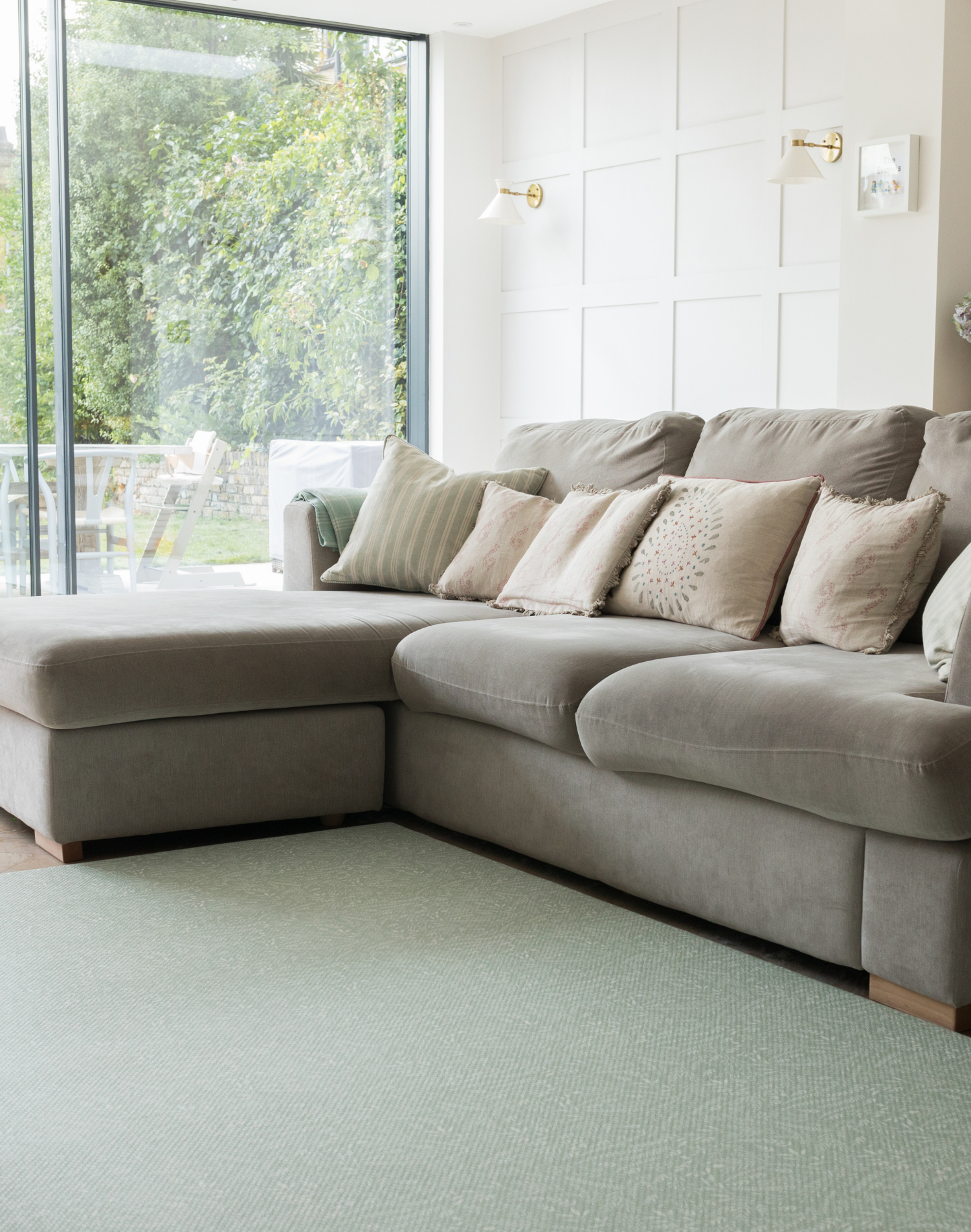 A living room looks modern with a green play mat that brings nature into the home 