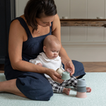 Mother and baby explore stacking cups on the groente speelmat that offers support and is extra comfortable 