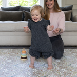 mum and baby playing on totter and tumble padded playmat foam play mat in morris & co heritage design severn, toddlers learning to walk on comfy padded playrug non slip textured surface easy to clean and wipedown washable play mat one piece and reversible to suit your family home