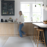 Lady walking across Foam mat made with quality materials and featuring neutral tan and beige design