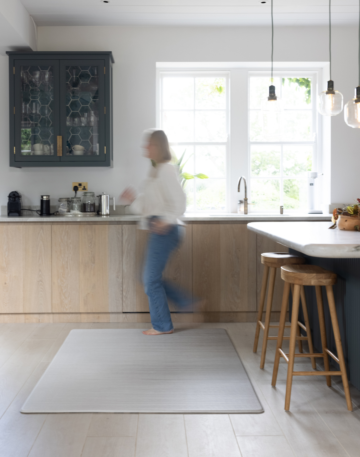 Lady walking across Foam mat made with quality materials and featuring neutral tan and beige design