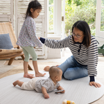 Mother and children on Round play mat for hard floors by Totter and Tumble so little ones don't feel the floor underneath with stylish tan and cream design for a stylish look 