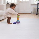 Baby stacking up wooden blocks on Baby play mats the whole family will love The Tali has a stylish ombre design with tan and beige tones