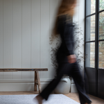 Lady walks across padded baby foam mat with grey leopard print motif that is subtle for the space 