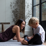 Mother and son enjoy time on the floor together protected on comfortabel spelmatta