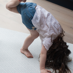 Little girl exercises on large non-slip play mat 