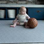 Baby playing on the reversible baby playmat The Seafarer and The Keeper luxury memory foam one piece stylish baby playmat